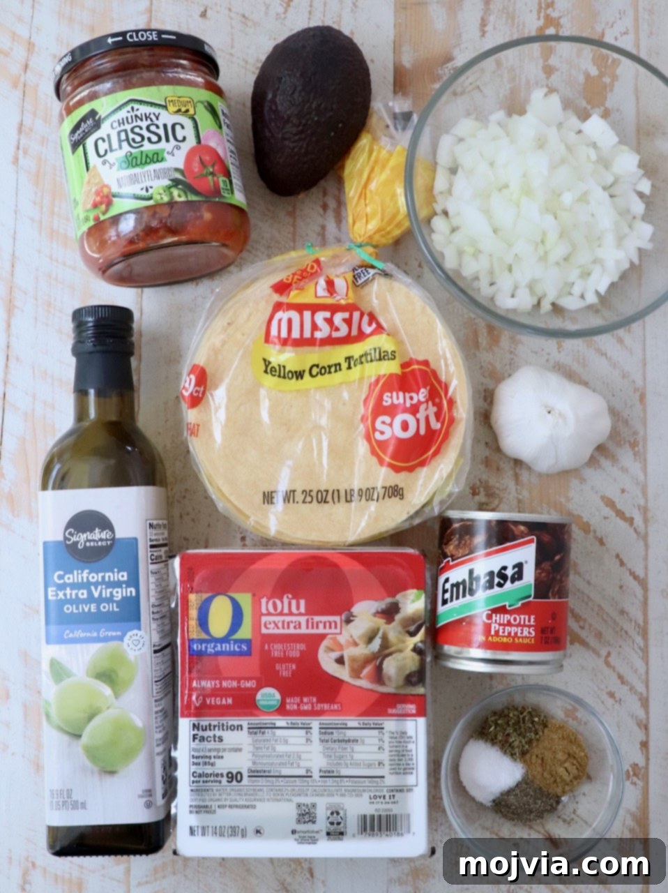 ingredients for tofu tacos on white wood board