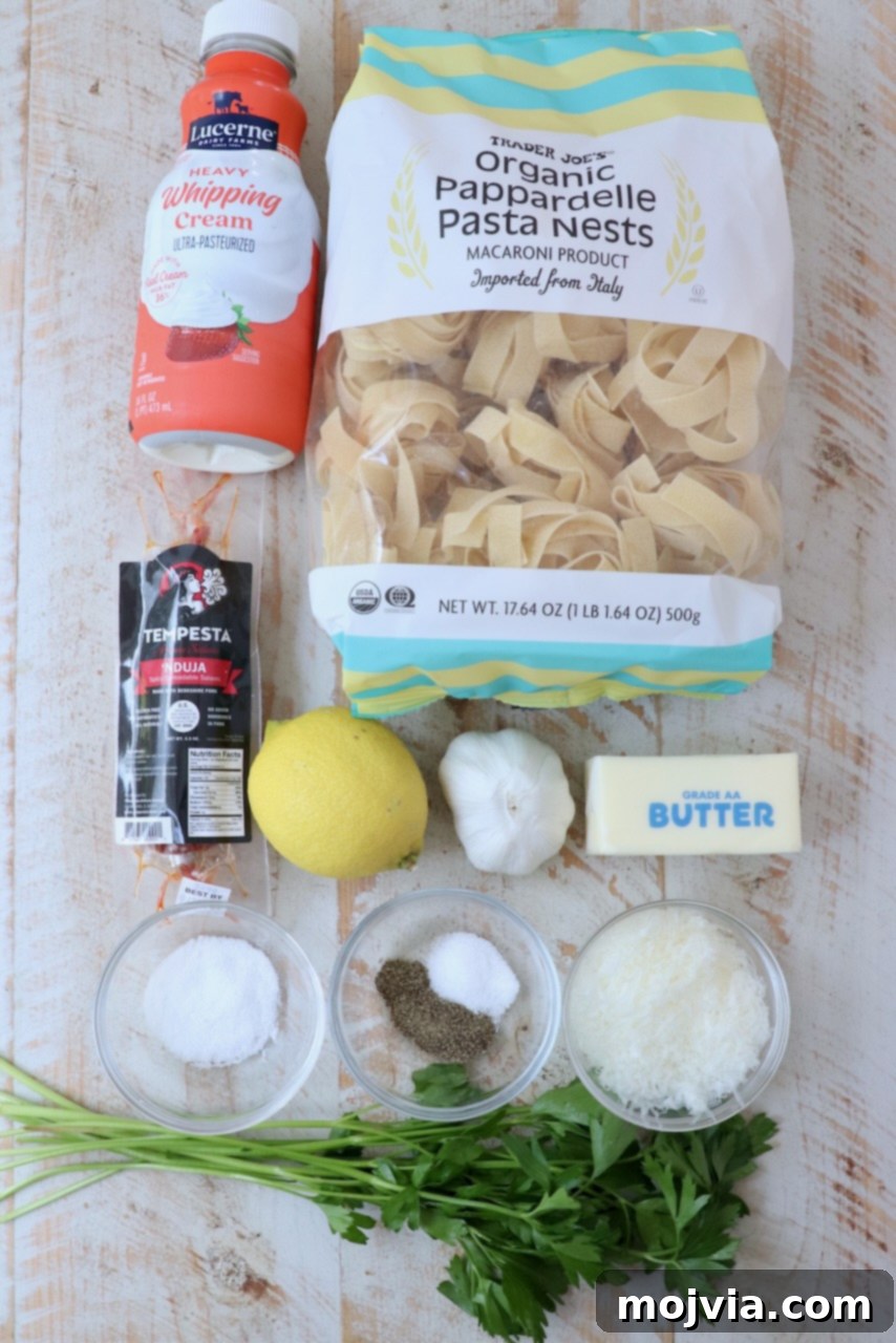 Calabrian Fire Pasta 3 ingredients for nduja pasta on white wood board