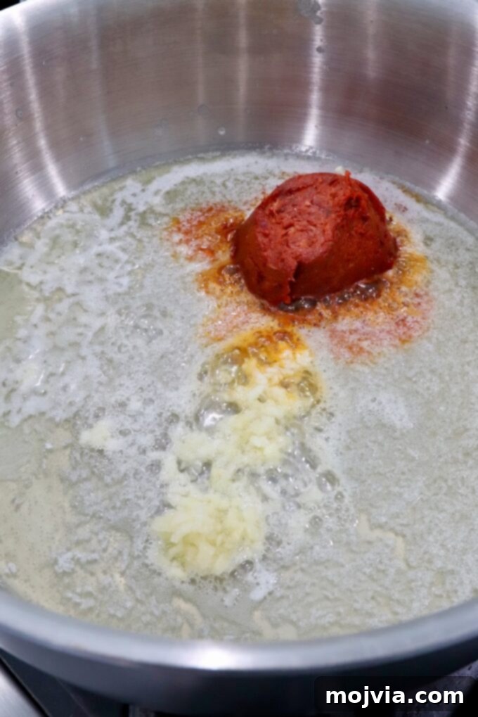 Calabrian Fire Pasta 4 minced garlic and spreadable salami in melted butter in pan