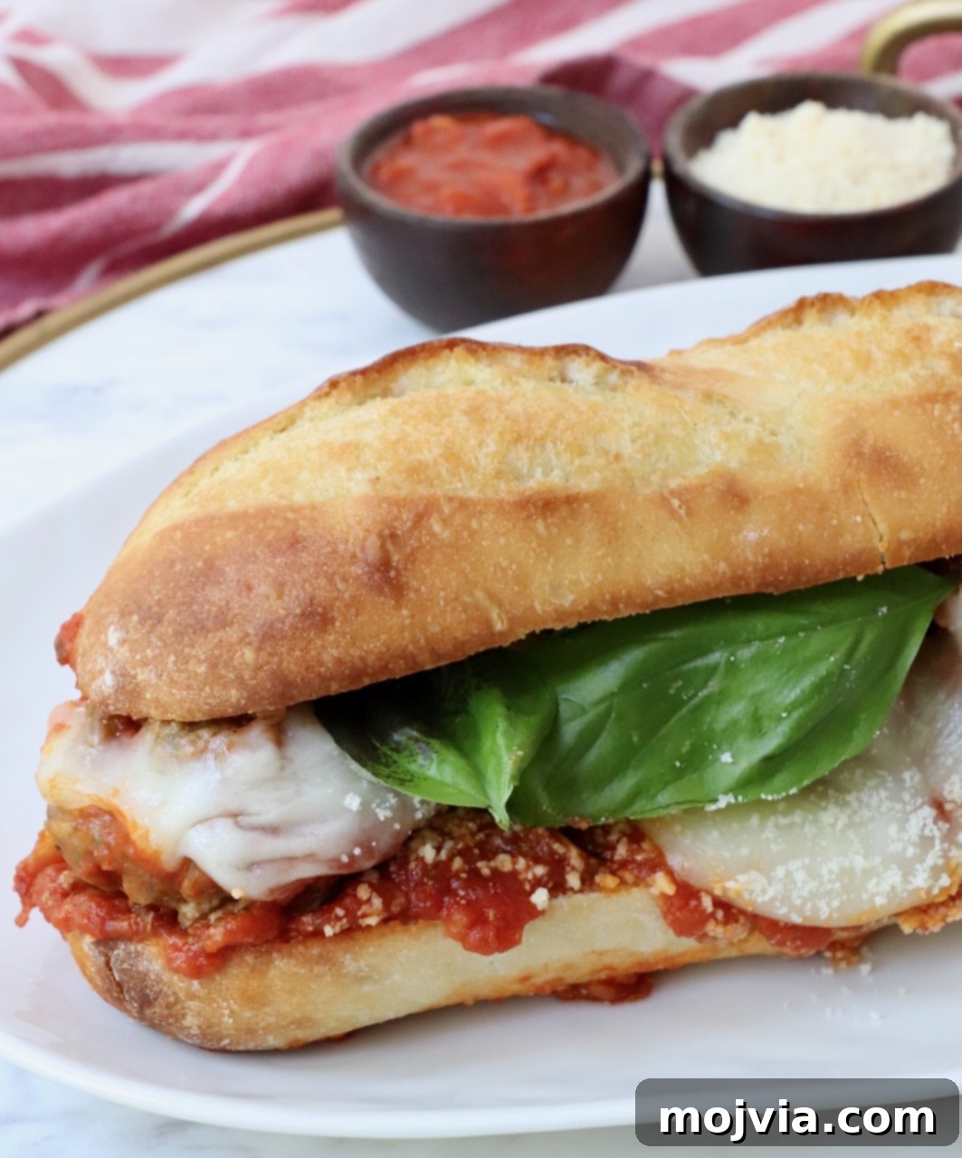 Perfectly assembled Italian meatball sub on a plate, ready to be enjoyed.