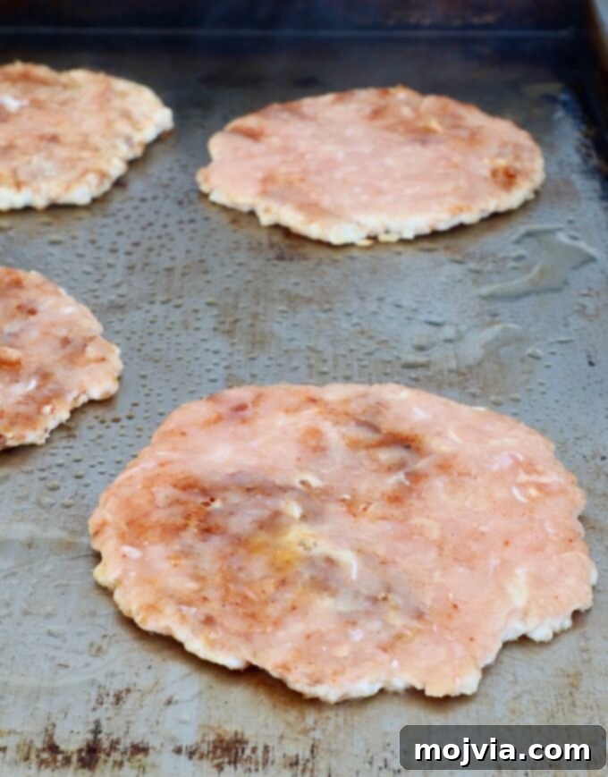 Spicy Buffalo Chicken Smash Burger 7 smashed chicken burger patties on a griddle