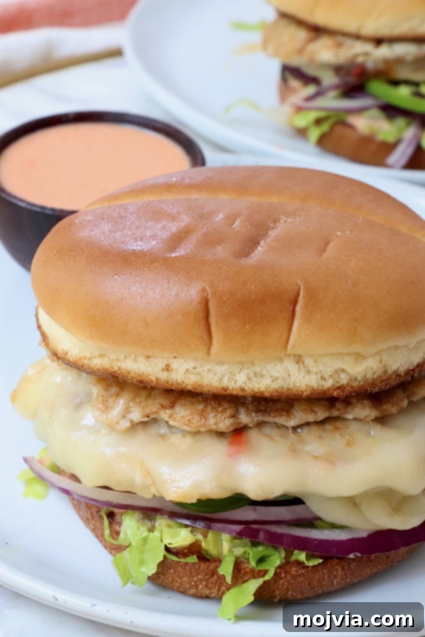 Spicy Buffalo Chicken Smash Burger 10 buffalo chicken smash burger on plate with small bowl of buffalo sauce on the side