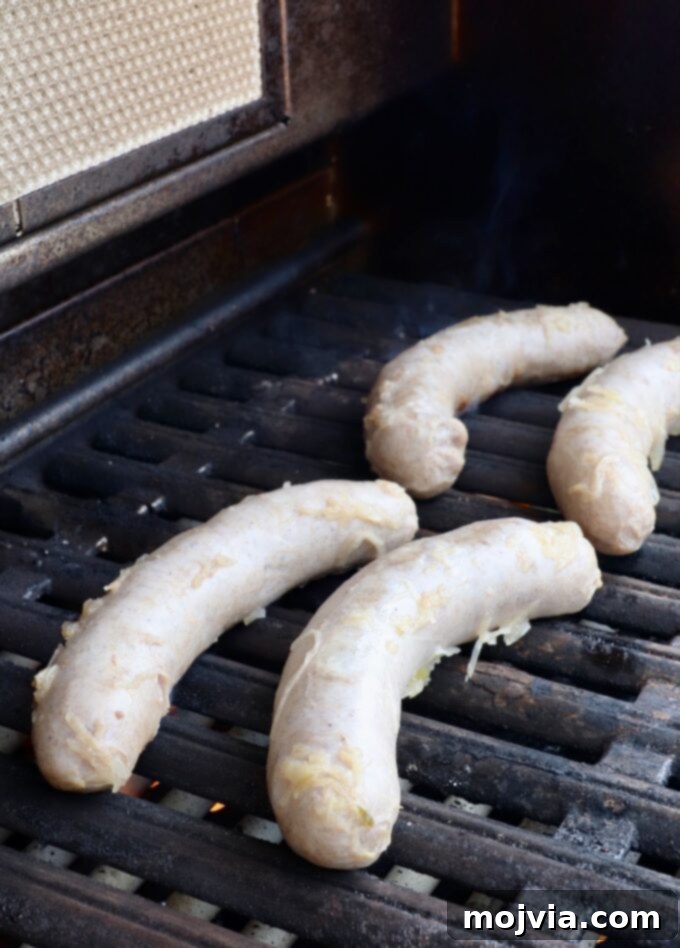 Bratwurst sausages carefully placed on a hot grill, ready to develop a delicious sear and smoky flavor.