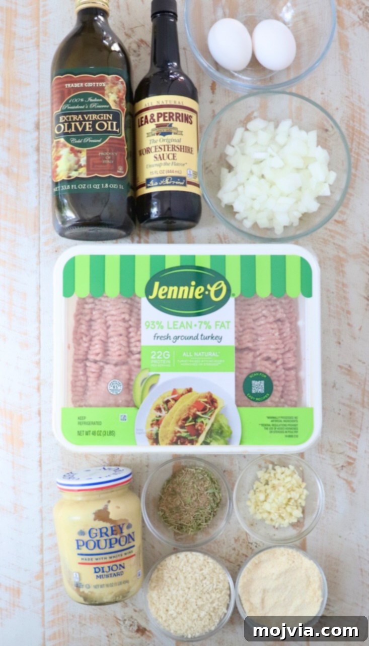 ingredients for turkey meatballs on a white wood board