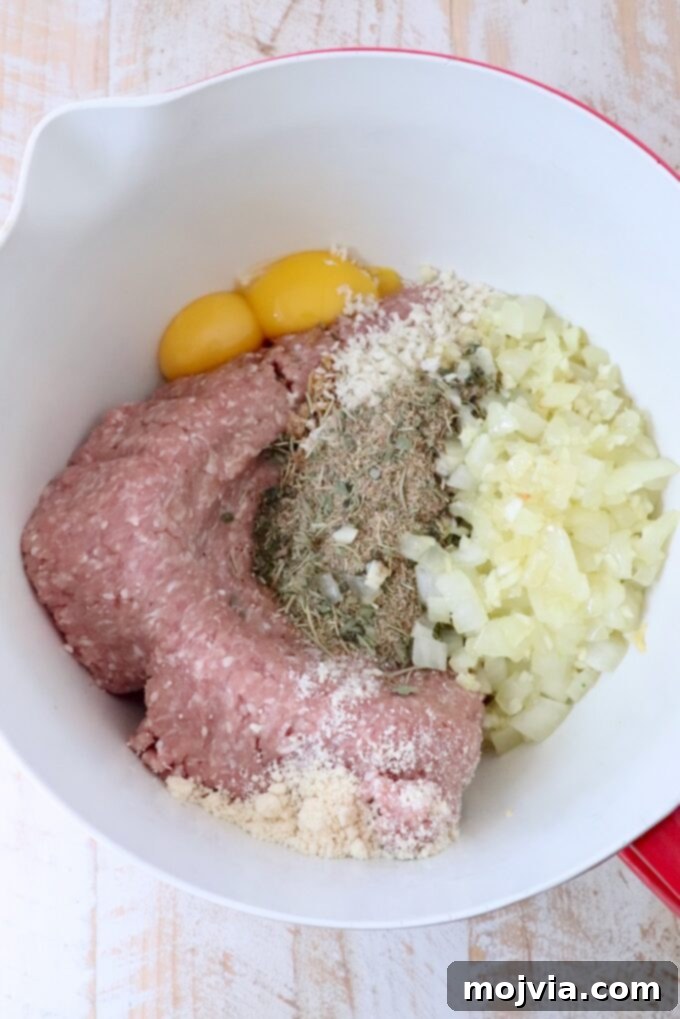 ingredients for turkey meatballs separated in a large mixing bowl