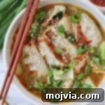 Comforting Gyoza Dumpling Soup 10 Gyoza soup in bowl with chopsticks on the side