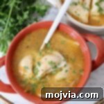 pierogi soup in bowl with a spoon