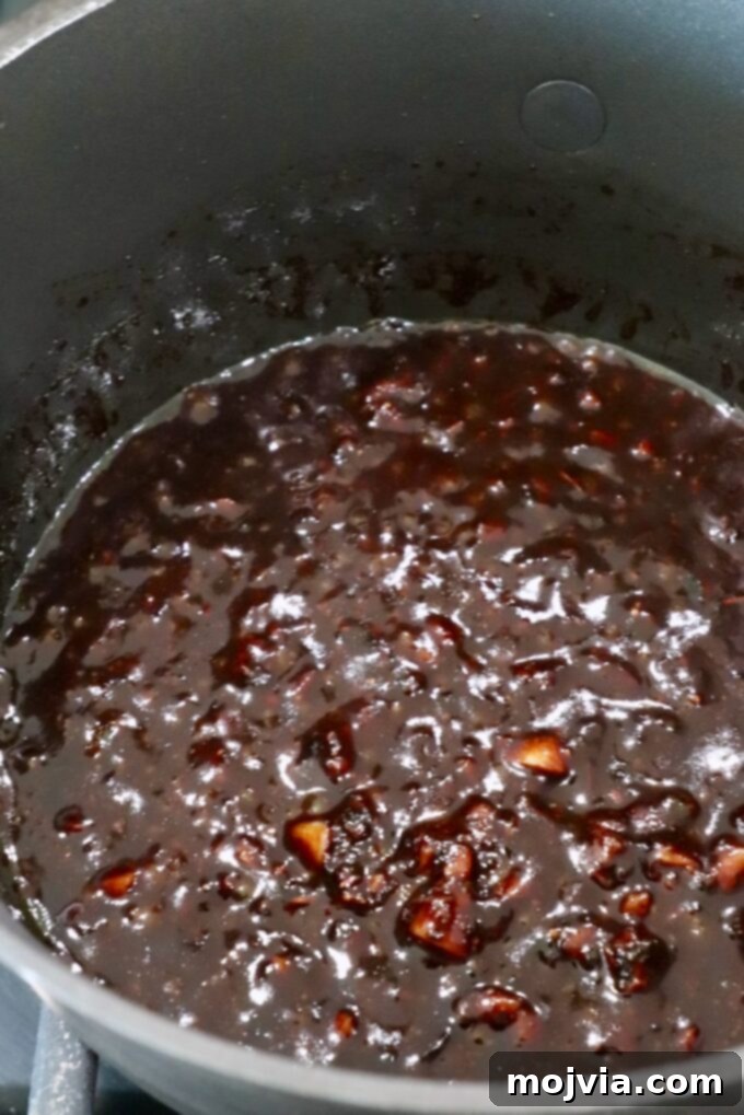 Sticky Balsamic Glazed Salmon 4 Balsamic glaze simmering in a small pot on the stove, showing its rich, thick consistency.