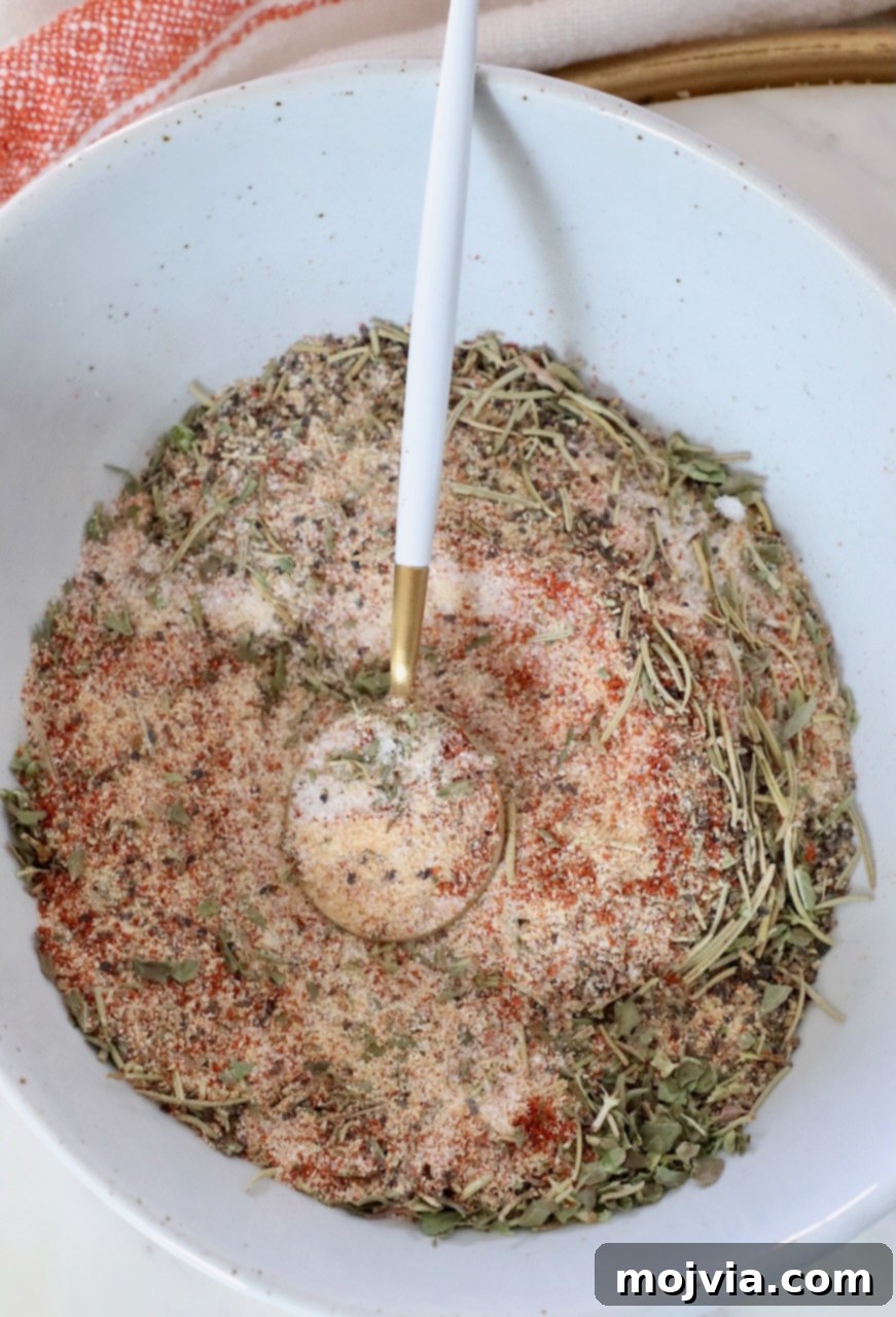 Ultimate Beef Stew Spice Mix 5 dried herbs and spices mixed together in a bowl with a spoon