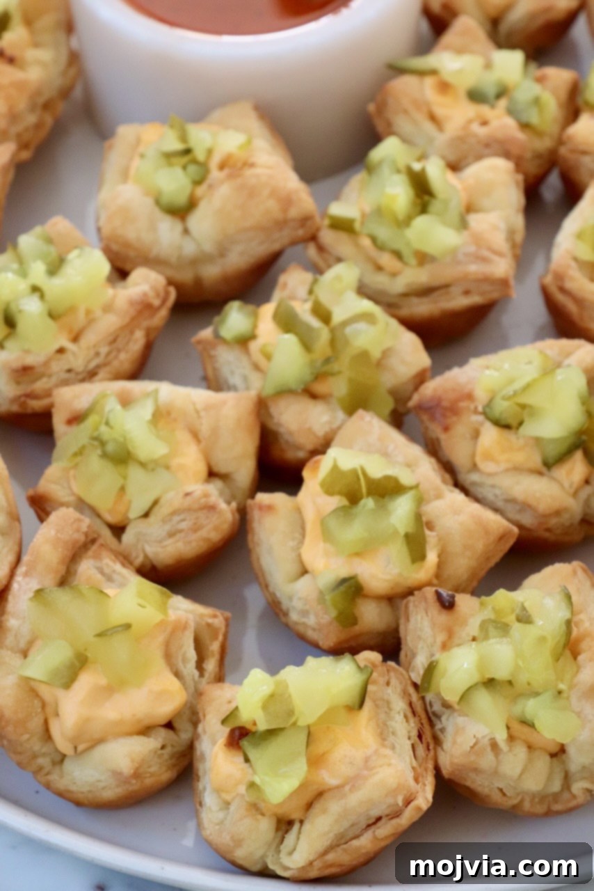 Dill Pickle Pastry Poppers 7 puff pastry pickles bites on a plate