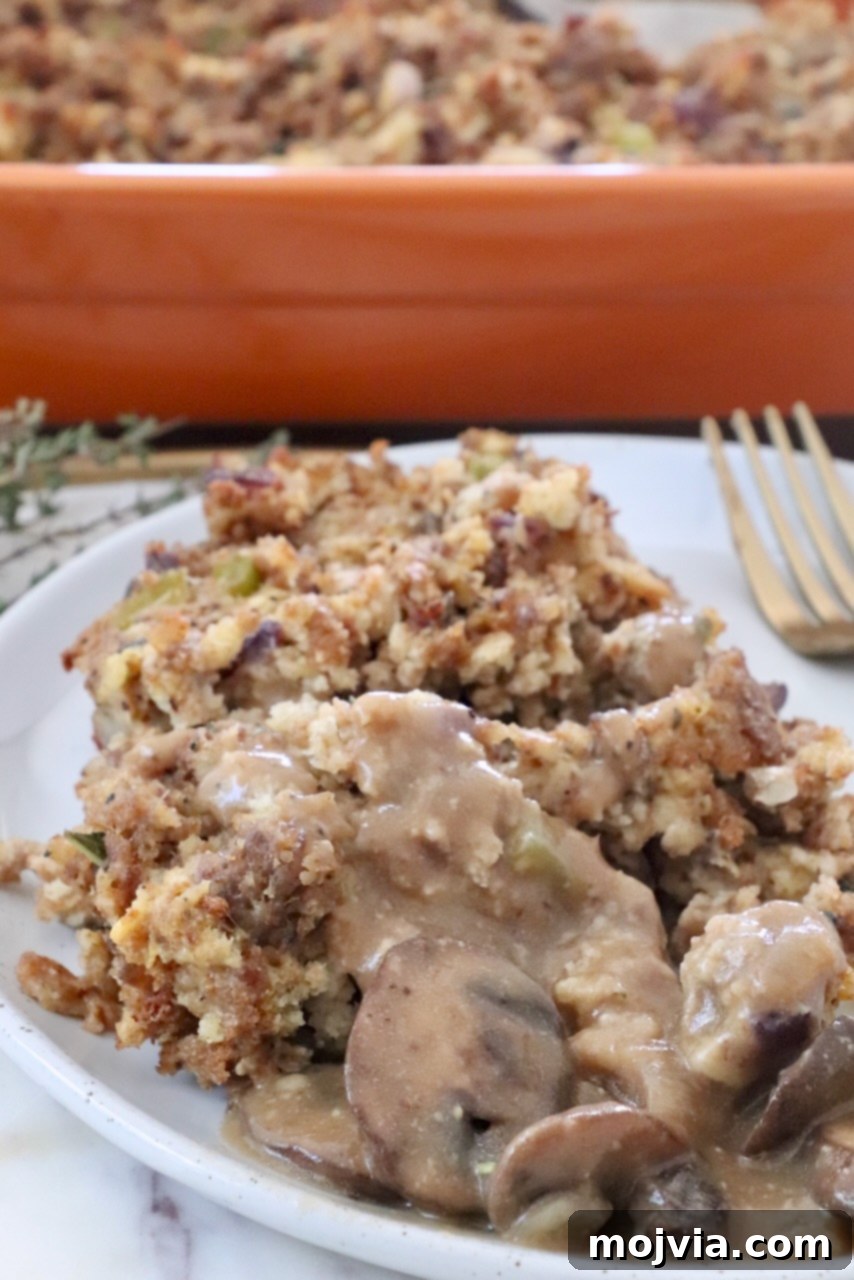 Wild Mushroom Gravy 11 Sausage stuffing on a plate generously topped with homemade mushroom gravy, ready to be enjoyed as a hearty meal.