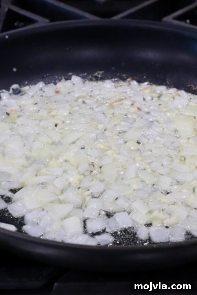 Ultimate Cheesy Potato Bake 4 diced onions and garlic in a skillet