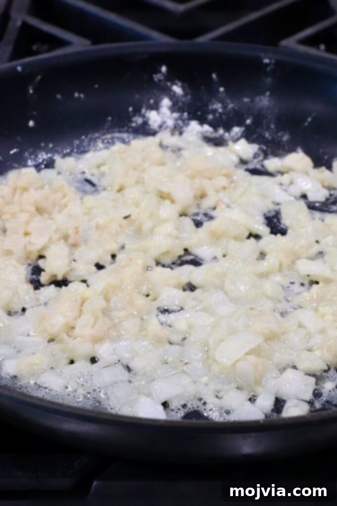 Ultimate Cheesy Potato Bake 5 diced onions and garlic in a skillet with flour