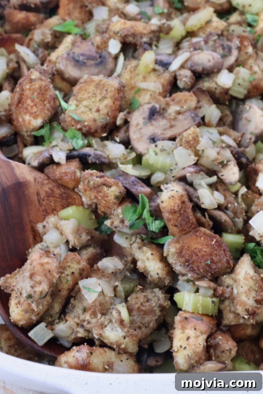 Umami Mushroom Stuffing 11 A generously portioned casserole dish of golden-brown mushroom stuffing, ready for serving at a festive meal.