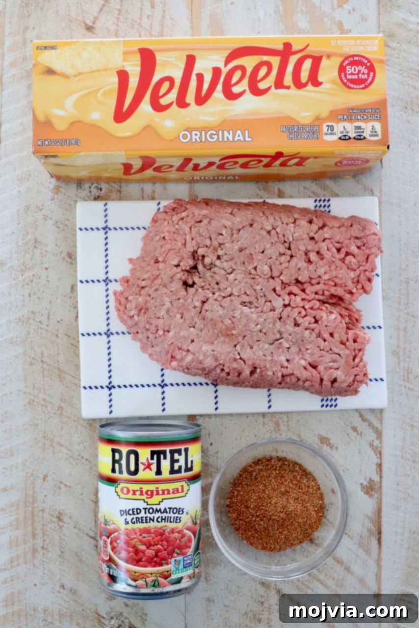 Irresistible Party Queso 3 ingredients in rotel dip on a white wood board