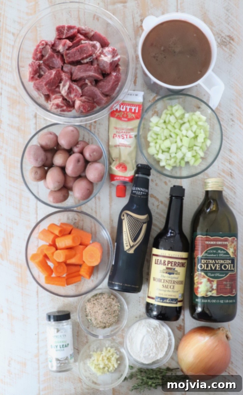 Ingredients for traditional Irish stew laid out on a white wooden board