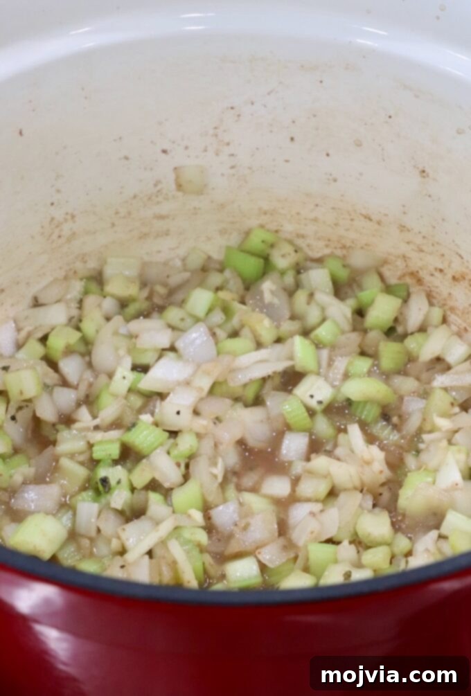 Diced onions and celery in a Dutch oven, deglazed with broth