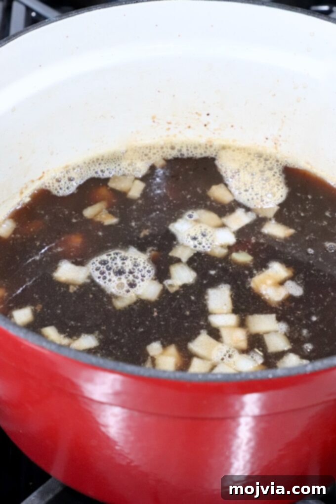 The stew simmering with all ingredients before going into the oven