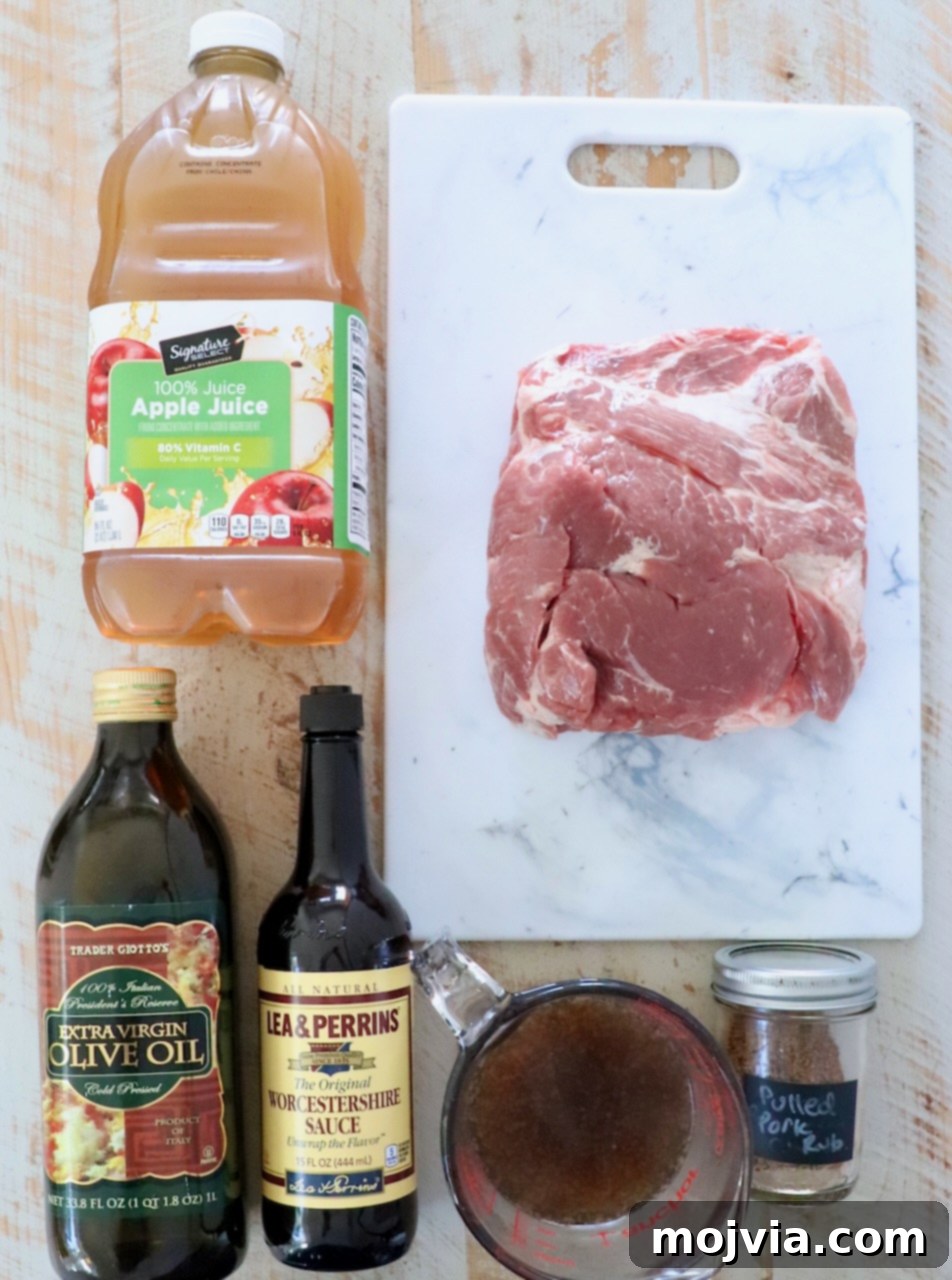 ingredients for pulled pork on a white wood board
