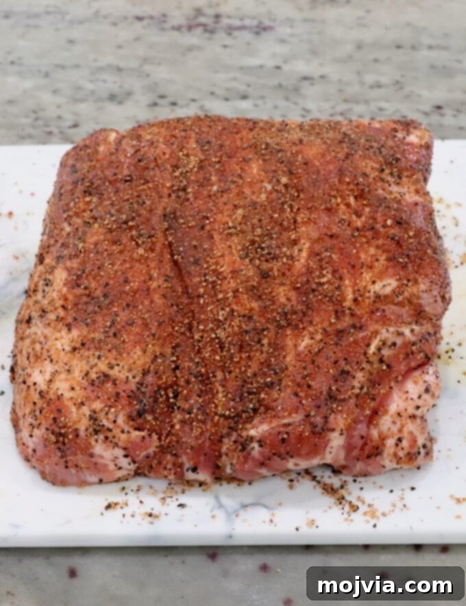 seasoned pork shoulder on a cutting board
