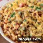 A bowl of freshly prepared American Goulash with melted cheddar cheese on top.