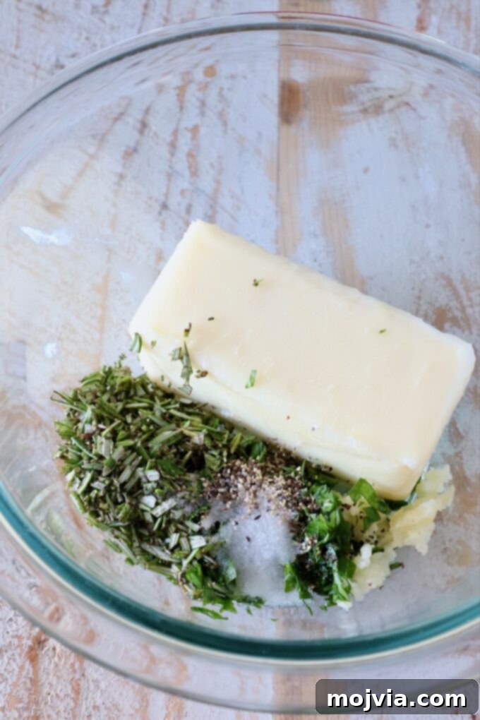 Butter Infusions 4 a stick of butter in a glass bowl with herbs, garlic and salt