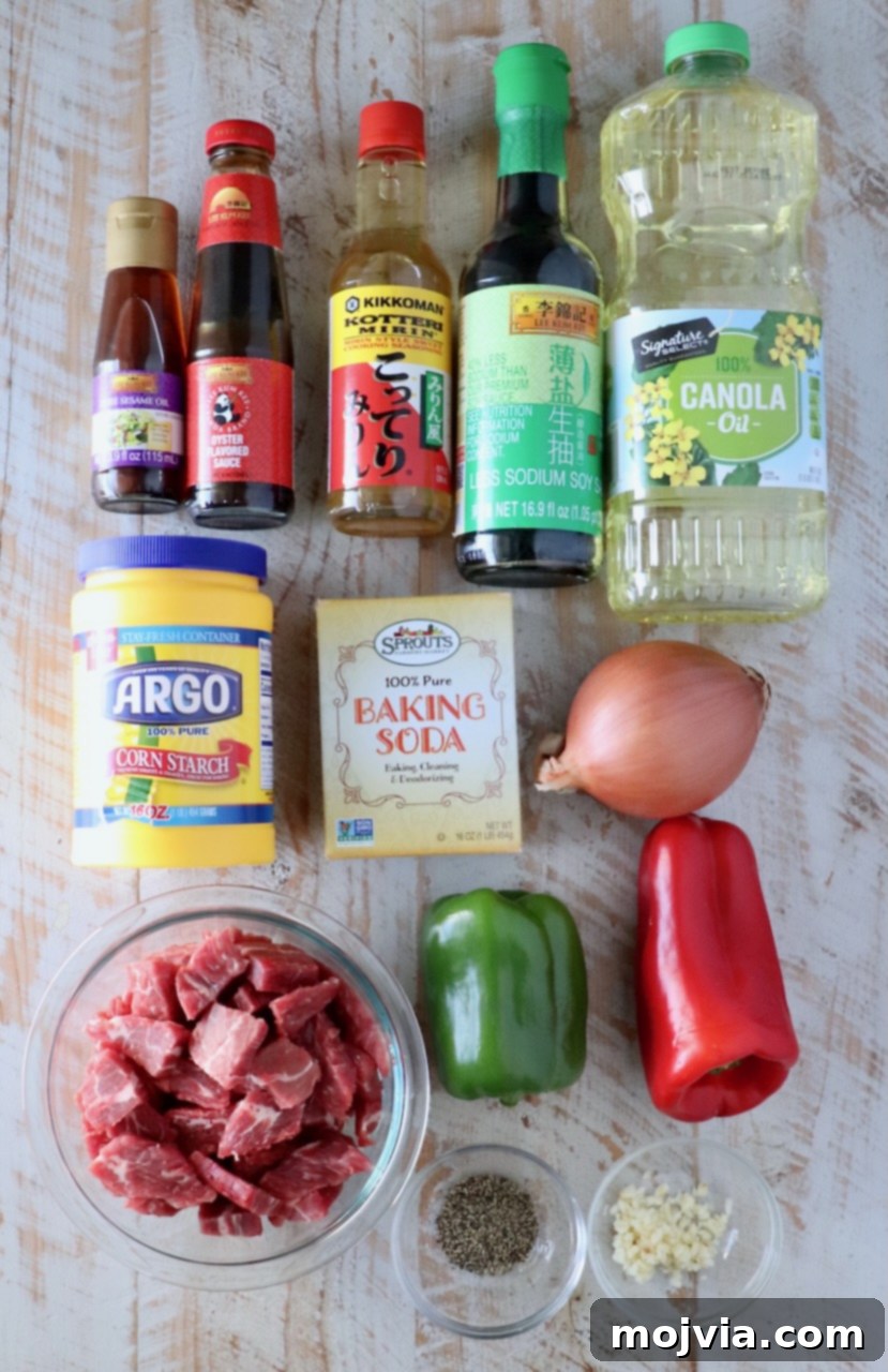 ingredients for pepper steak on a white wood board