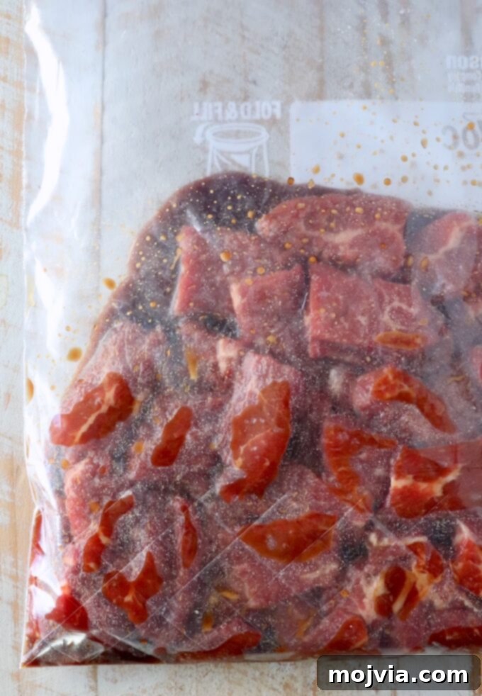 slices of beef in marinade in a plastic zipper bag