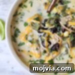 chicken poblano soup in a bowl with a spoon