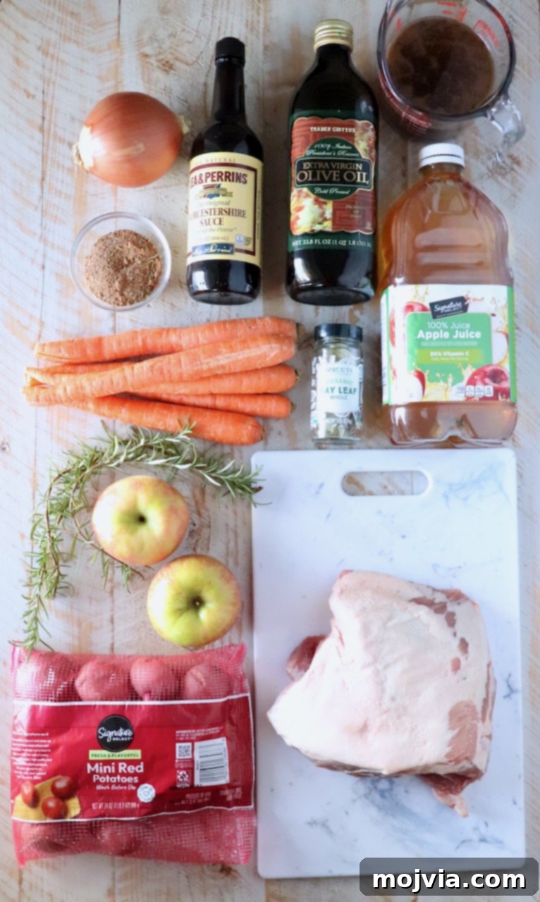 ingredients for pork roast on a white wood board