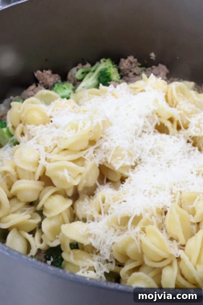 Savory Sausage and Broccoli Orecchiette 8 cooked pasta in a large pot topped with grated cheese