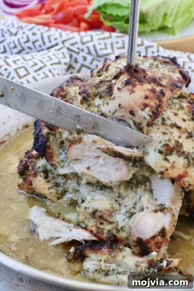 Greek Style Chicken Gyros 7 chicken sliced from a rotisserie with a large knife
