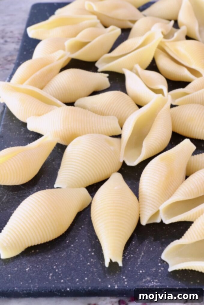 Cheesy Baked Stuffed Shells 4 cooked jumbo pasta shells on a cutting board