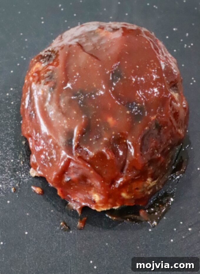 Golden Air Fryer Meatloaf 9 Cooked, glazed meatloaf on a cutting board