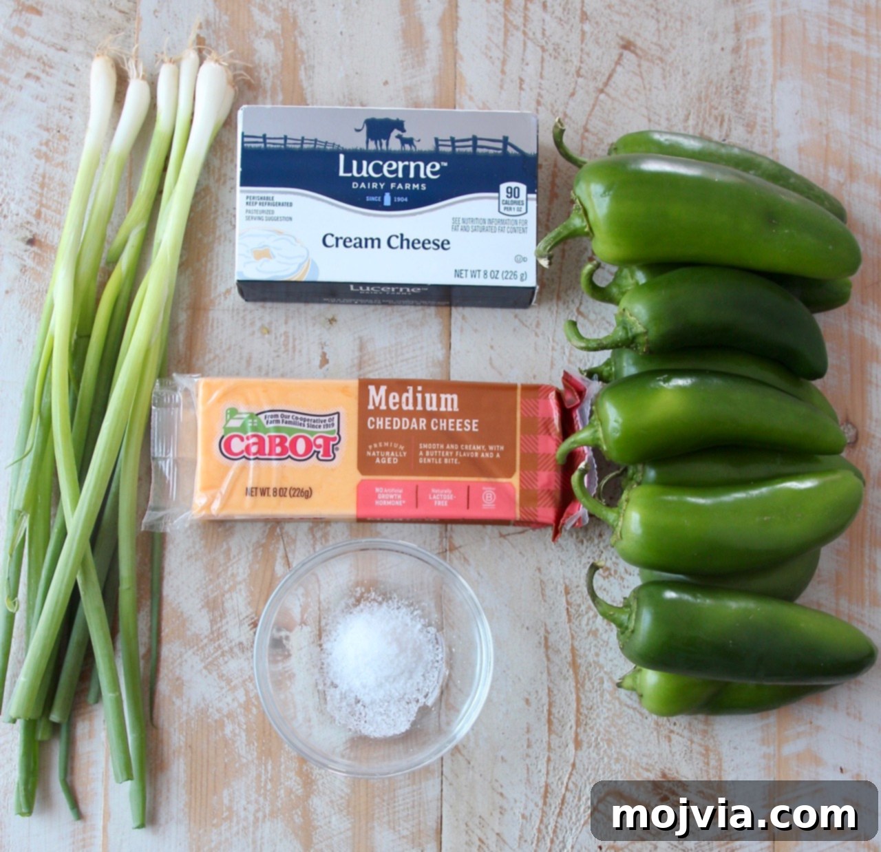 Smoky Cheesy Jalapeño Bites 3 Ingredients laid out for making grilled jalapeno poppers, including fresh peppers, cream cheese, cheddar, and green onions.