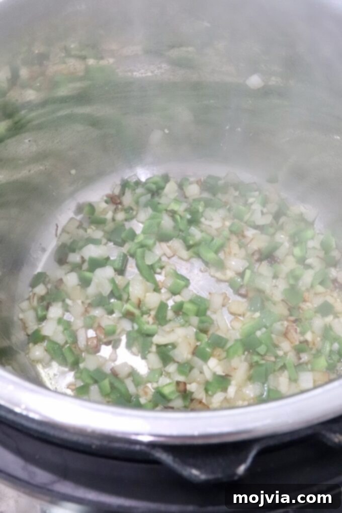 Speedy Instant Pot Mexican Rice 4 Diced onions, jalapenos, and garlic sautéing in an Instant Pot base
