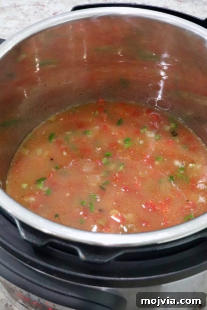 Speedy Instant Pot Mexican Rice 6 All ingredients, including diced vegetables, seasoned broth, and rice, combined in an Instant Pot before pressure cooking