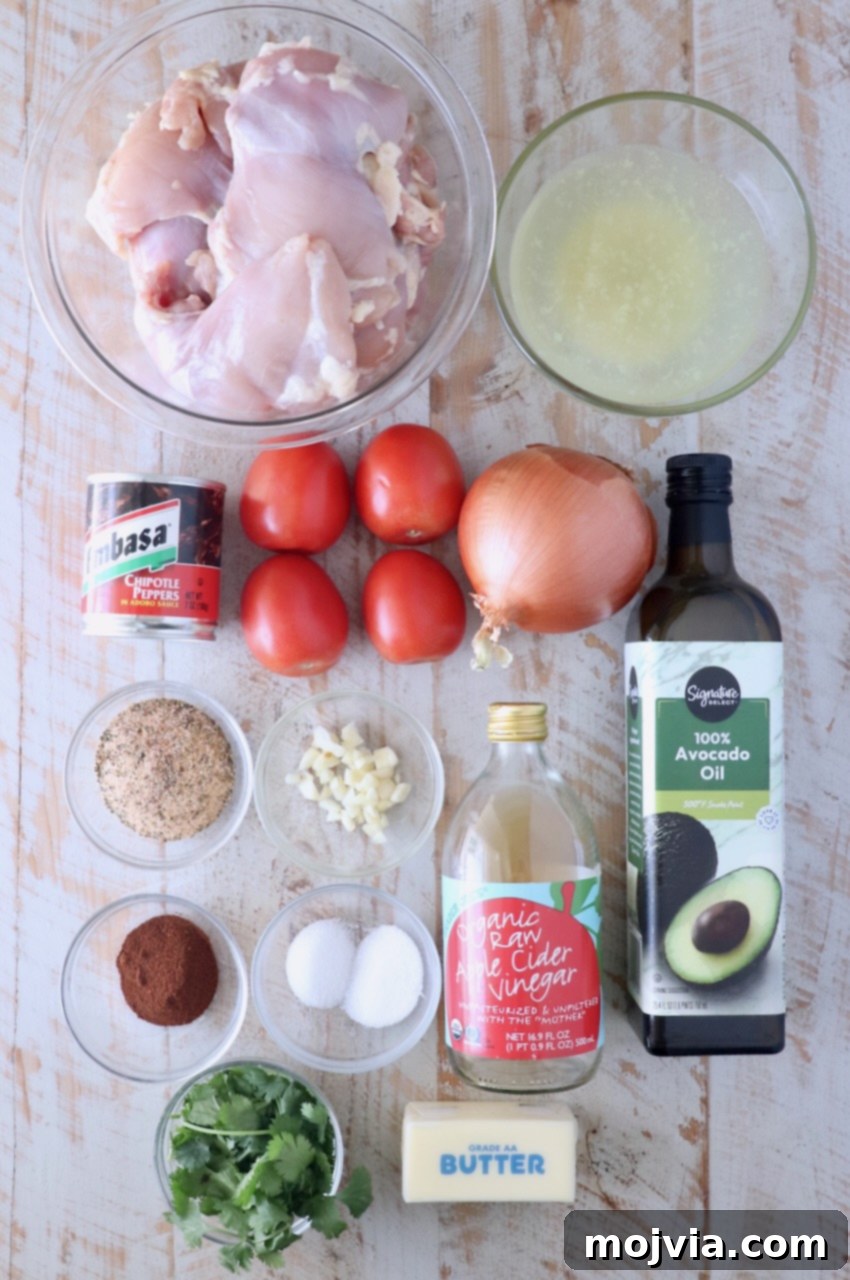 Ingredients for Mexican Chicken Adobo laid out on a white wooden board