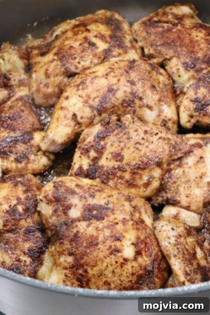 Beautifully seared chicken thighs in a large Dutch oven