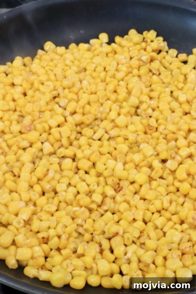 Esquites Style Corn Salad 5 corn kernels in a skillet