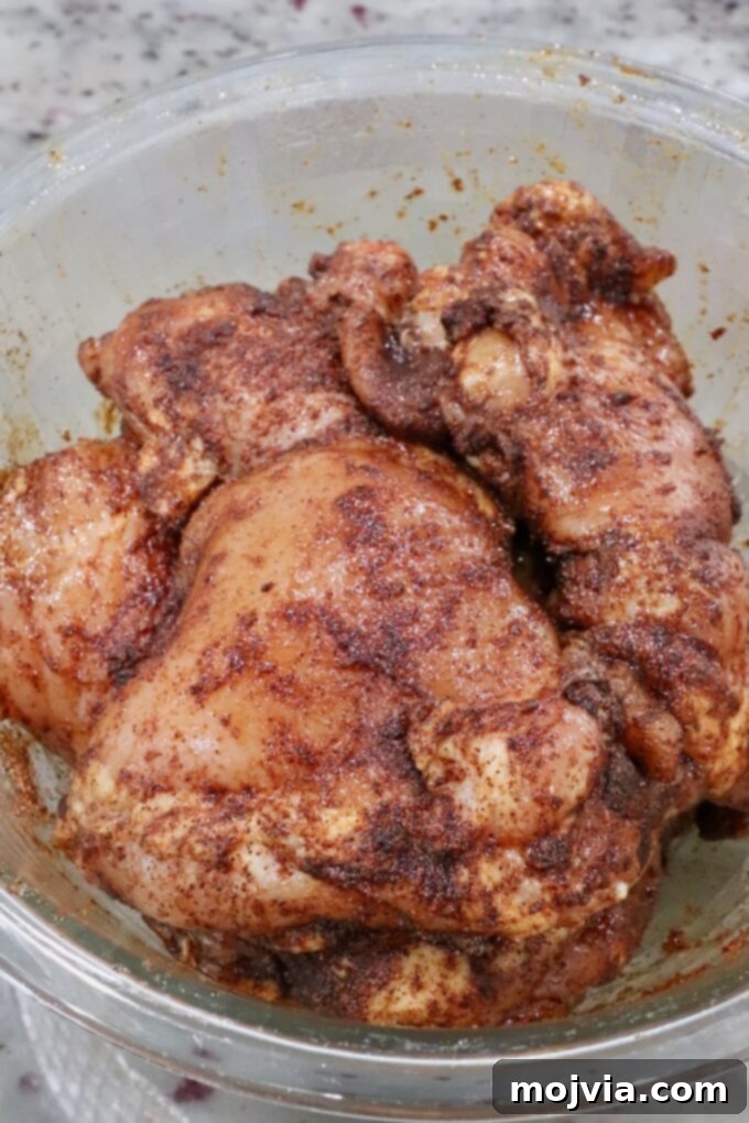 Chipotle Honey Glazed Chicken 6 seasoned chicken thighs in a glass bowl, coated evenly with spices