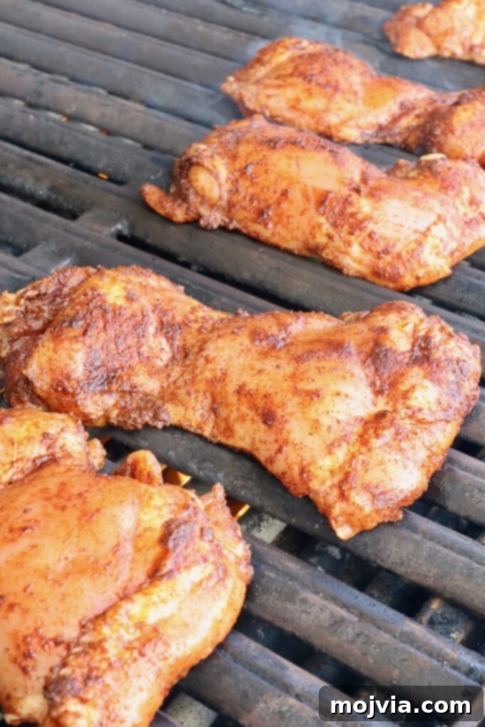 Chipotle Honey Glazed Chicken 7 seasoned raw chicken thighs placed on a hot grill, ready for cooking