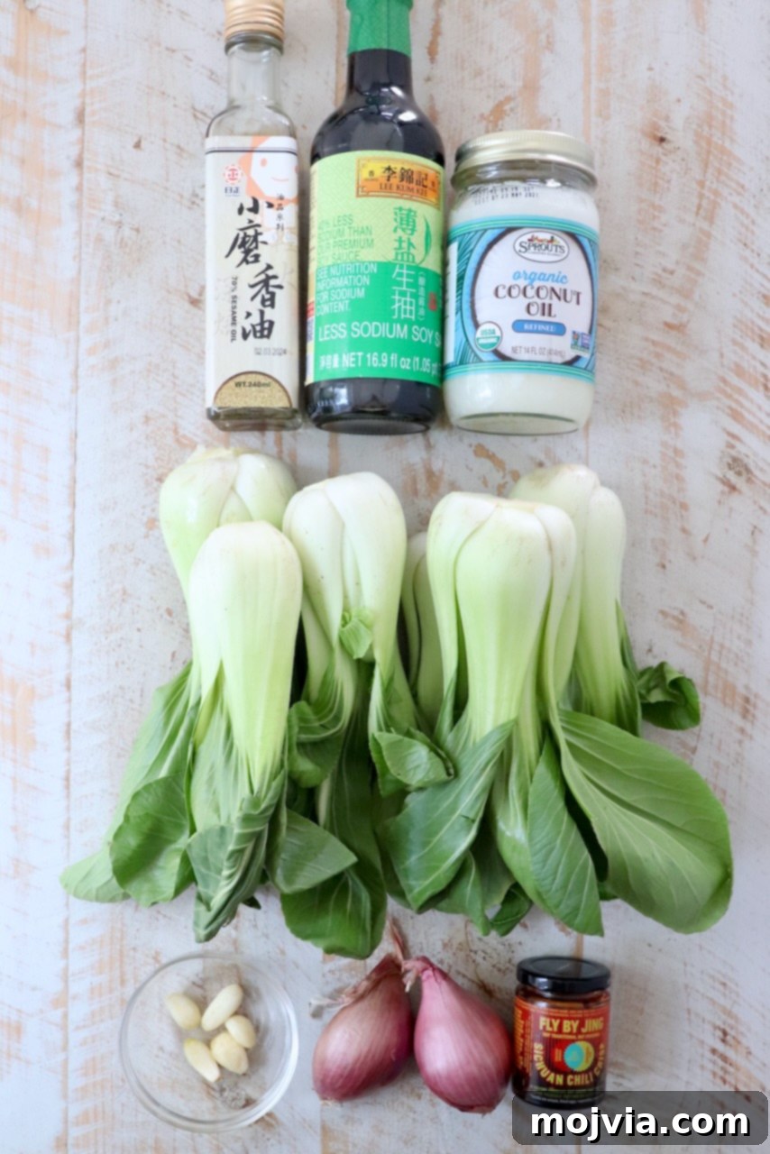 Petite Bok Choy 3 ingredients for baby bok choy on a white wood board