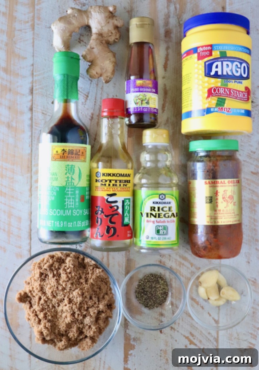 Authentic Korean BBQ Sauce 3 All the fresh and pantry ingredients laid out on a white wooden board, ready to be combined for the Korean BBQ sauce.