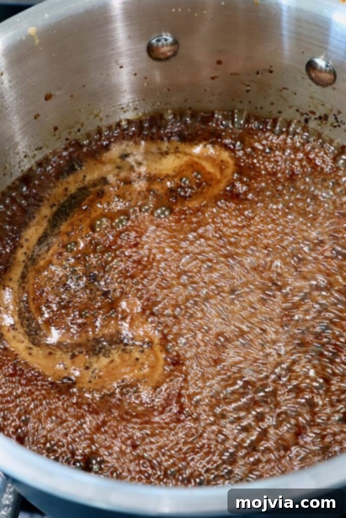 Authentic Korean BBQ Sauce 4 Homemade Korean BBQ sauce simmering gently in a saucepan on the stove, releasing aromatic steam.