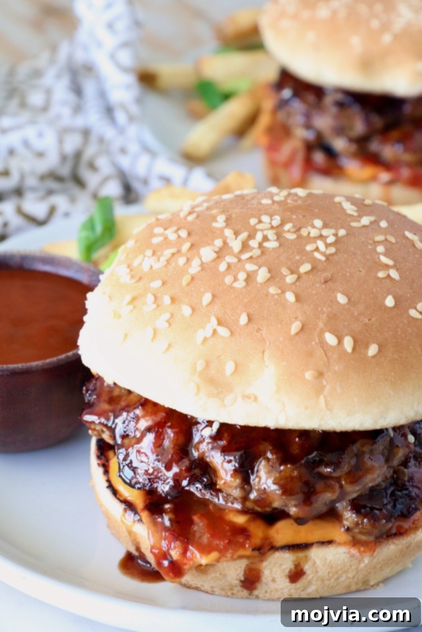 Prepared Korean BBQ Burger on a plate with homemade Korean BBQ sauce and crispy French fries