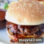 Burger covered in Korean BBQ sauce on a plate