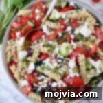 pasta salad in a bowl with a spoon