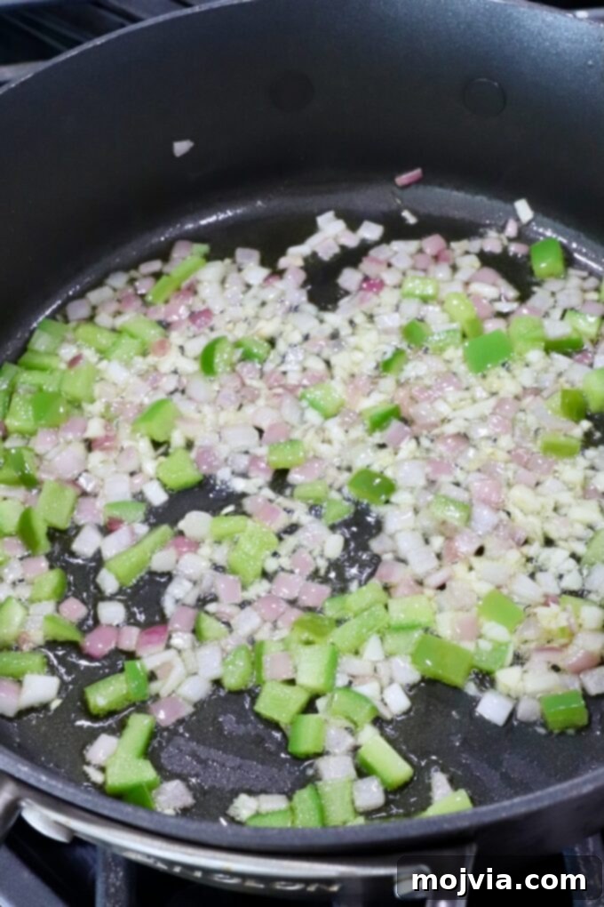 Aegean Breeze Pasta Medley 4 diced onion and bell pepper in a skillet on the stove