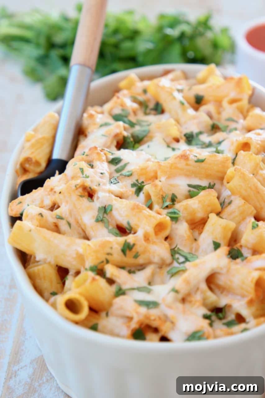 Spicy Buffalo Chicken Pasta Bake 2 Buffalo chicken baked pasta in casserole dish with serving spoon